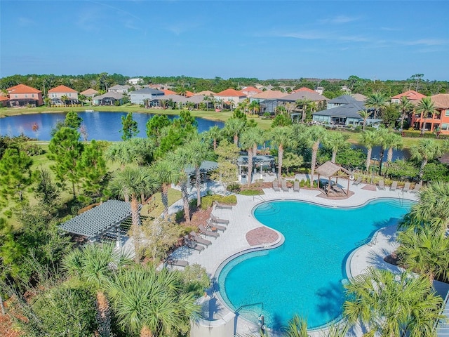 community pool with a patio, a water view, and a residential view