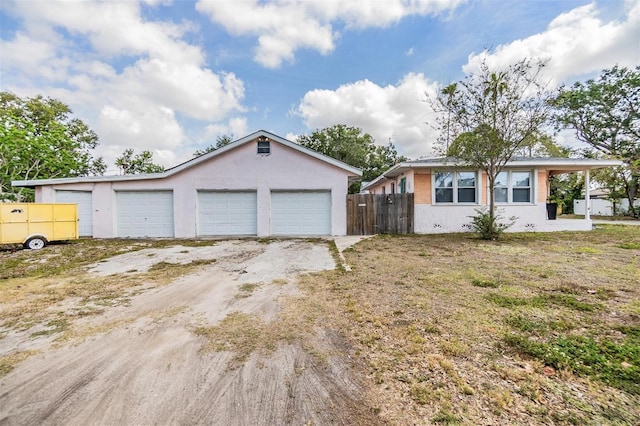 5101 13th Ave S, Gulfport, FL 33707 - ranch-style home with fence, a detached garage, and stucco siding