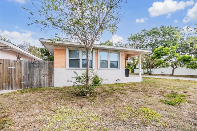5101 13th Ave S, Gulfport, FL 33707 - view of side of home with a lawn and fence