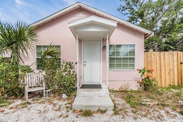 5101 13th Ave S, Gulfport, FL 33707 - doorway to property featuring fence and stucco siding