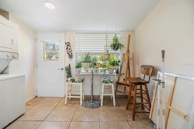 5101 13th Ave S, Gulfport, FL 33707 - dining space with tile patterned floors, baseboards, and stacked washer / dryer