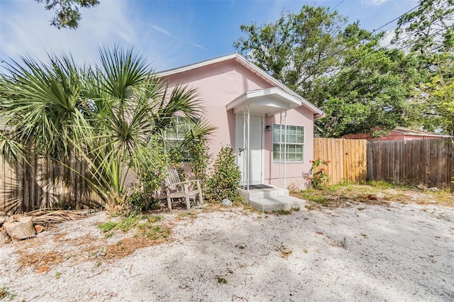 5101 13th Ave S, Gulfport, FL 33707 - view of front facade with fence and stucco siding