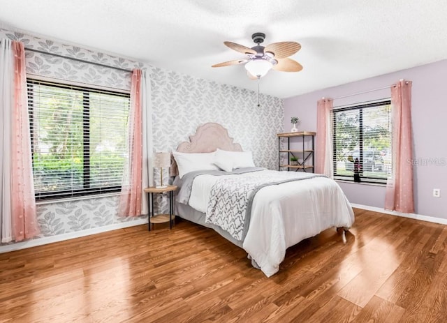 1281 Pine Ridge Cir E Unit H1, Tarpon Springs, FL 34688 - bedroom featuring baseboards, wood finished floors, and wallpapered walls