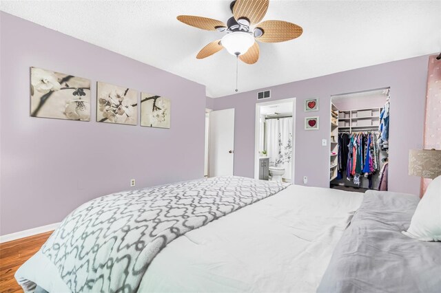 1281 Pine Ridge Cir E Unit H1, Tarpon Springs, FL 34688 - bedroom with visible vents, a closet, wood finished floors, baseboards, and a spacious closet