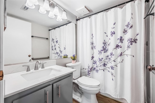 1281 Pine Ridge Cir E Unit H1, Tarpon Springs, FL 34688 - bathroom with visible vents, curtained shower, wood finished floors, vanity, and toilet