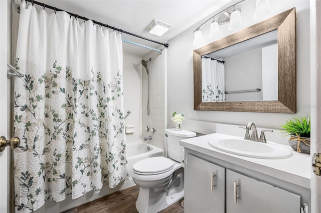1281 Pine Ridge Cir E Unit H1, Tarpon Springs, FL 34688 - full bath with visible vents, vanity, wood finished floors, shower / bath combination with curtain, and toilet