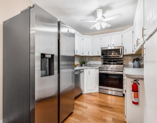 1281 Pine Ridge Cir E Unit H1, Tarpon Springs, FL 34688 - kitchen with a sink, appliances with stainless steel finishes, a textured ceiling, and light countertops