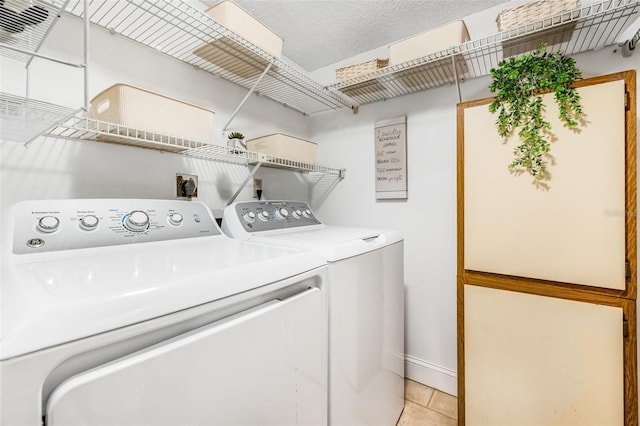 1281 Pine Ridge Cir E Unit H1, Tarpon Springs, FL 34688 - clothes washing area with light tile patterned floors, baseboards, laundry area, and independent washer and dryer