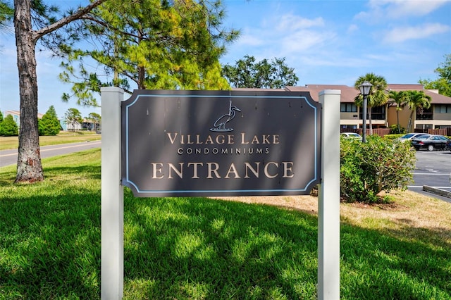 710 N Village Dr N Unit 102, Saint Petersburg, FL 33716 - community sign featuring a yard and uncovered parking