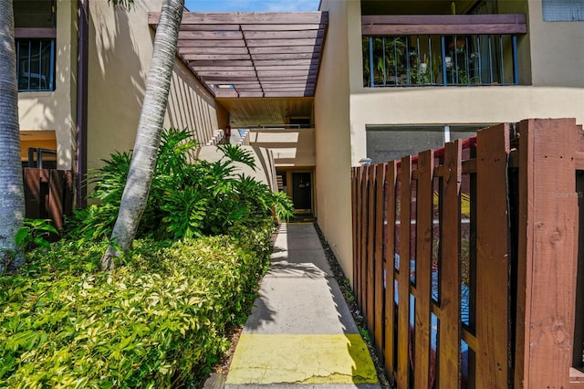 710 N Village Dr N Unit 102, Saint Petersburg, FL 33716 - view of home's exterior with stucco siding and fence