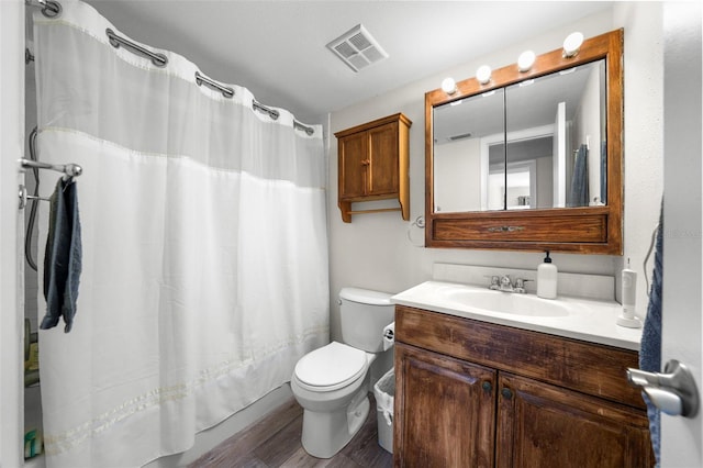 710 N Village Dr N Unit 102, Saint Petersburg, FL 33716 - full bath featuring wood finished floors, toilet, vanity, and shower / bath combination with curtain