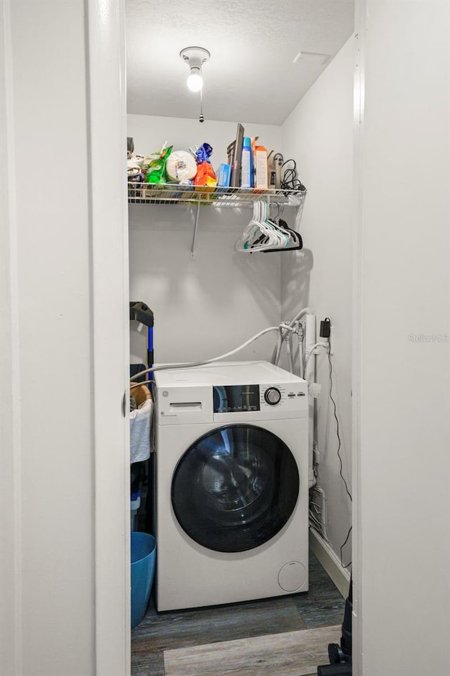 710 N Village Dr N Unit 102, Saint Petersburg, FL 33716 - laundry room featuring washer / dryer, wood finished floors, and a textured ceiling