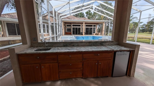 4872 Silverthorne Ct, Oldsmar, FL 34677 - view of patio featuring a sink, a lanai, and an outdoor pool