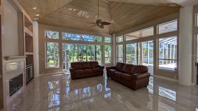 4872 Silverthorne Ct, Oldsmar, FL 34677 - living area featuring a high ceiling, wood ceiling, a premium fireplace, baseboards, and ceiling fan