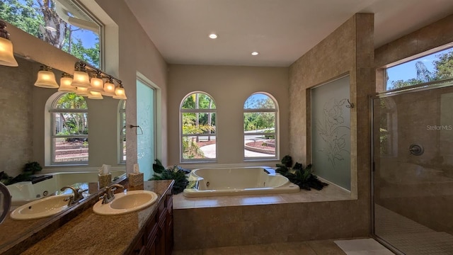 4872 Silverthorne Ct, Oldsmar, FL 34677 - bathroom featuring a tub with jets, vanity, a shower stall, tile patterned floors, and recessed lighting
