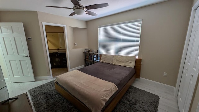 4872 Silverthorne Ct, Oldsmar, FL 34677 - bedroom featuring baseboards, connected bathroom, light wood-type flooring, and a ceiling fan