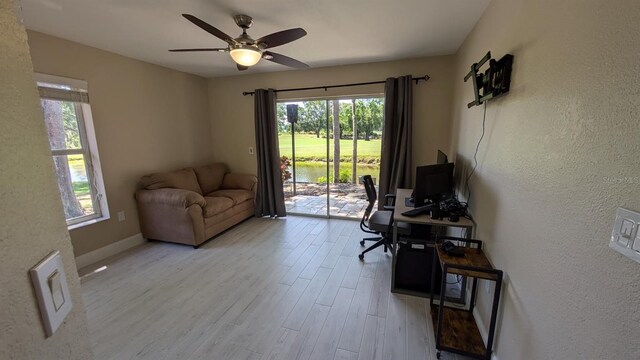 4872 Silverthorne Ct, Oldsmar, FL 34677 - office with plenty of natural light, wood finished floors, a ceiling fan, a textured wall, and baseboards