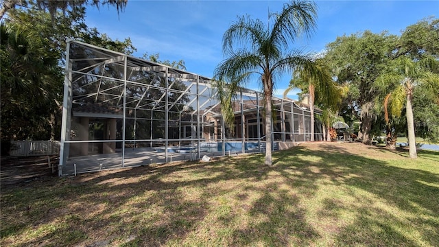 4872 Silverthorne Ct, Oldsmar, FL 34677 - rear view of property featuring a lawn, an outdoor pool, and glass enclosure