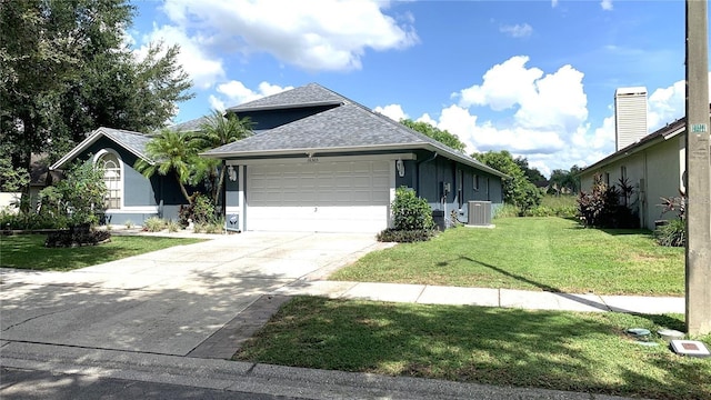 ranch-style house featuring roof with shingles, a garage, a front yard, concrete driveway, and cooling unit