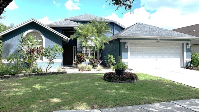 view of front facade with a garage, a front lawn, stucco siding, a shingled roof, and concrete driveway