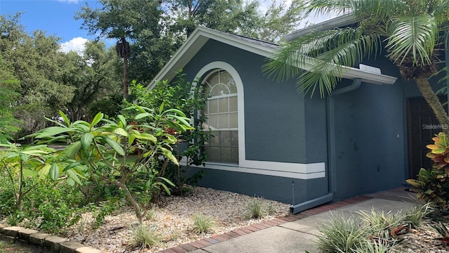 view of side of home with stucco siding