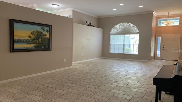 entrance foyer featuring baseboards, stone tile floors, crown molding, and recessed lighting