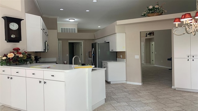 kitchen with visible vents, freestanding refrigerator, ornamental molding, light countertops, and electric range oven