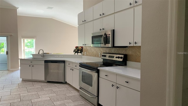 kitchen with a sink, light countertops, stainless steel appliances, decorative backsplash, and ornamental molding