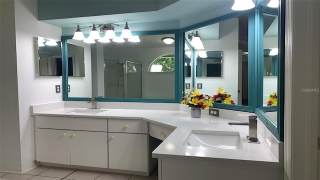 full bathroom with double vanity, a sink, tile patterned floors, and a shower stall