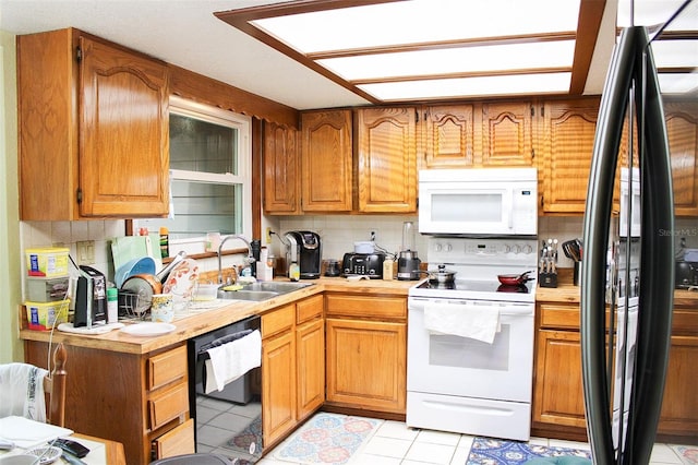 16536 Caldwell Ln, Spring Hill, FL 34610 - kitchen with white appliances, decorative backsplash, a sink, and light countertops
