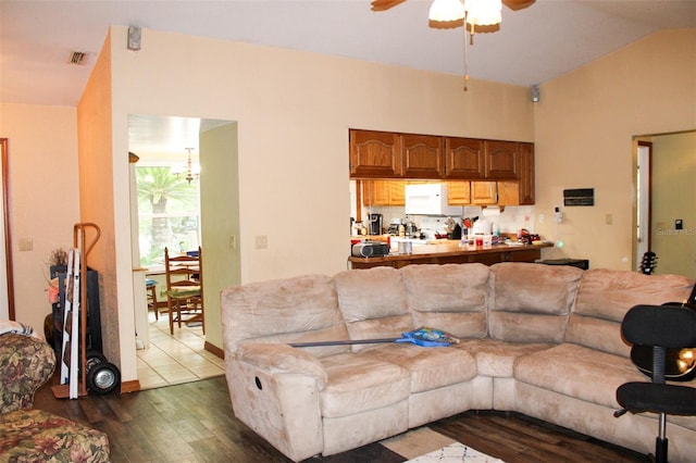 16536 Caldwell Ln, Spring Hill, FL 34610 - living room with ceiling fan, vaulted ceiling, dark wood-style flooring, and visible vents