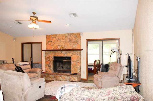 16536 Caldwell Ln, Spring Hill, FL 34610 - living room with ceiling fan, visible vents, a stone fireplace, and wood finished floors
