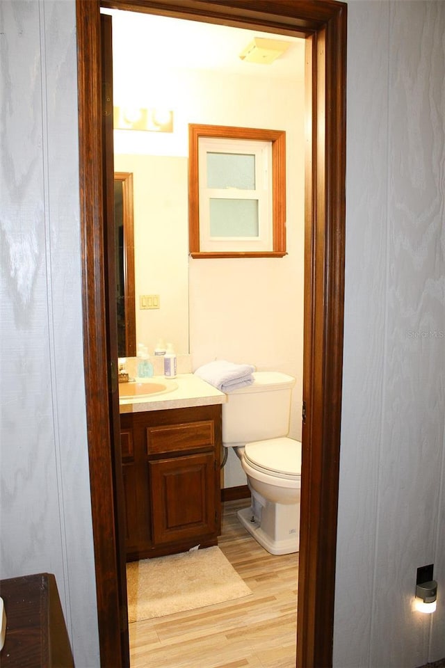 16536 Caldwell Ln, Spring Hill, FL 34610 - half bathroom featuring vanity, toilet, and wood finished floors