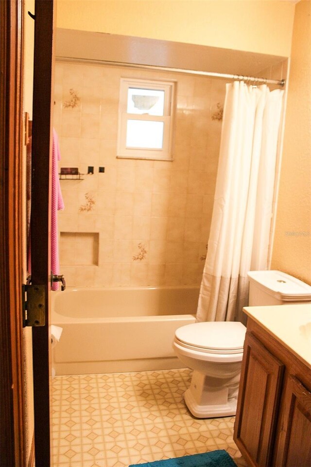 16536 Caldwell Ln, Spring Hill, FL 34610 - full bath with vanity, shower / tub combo, tile patterned floors, and toilet