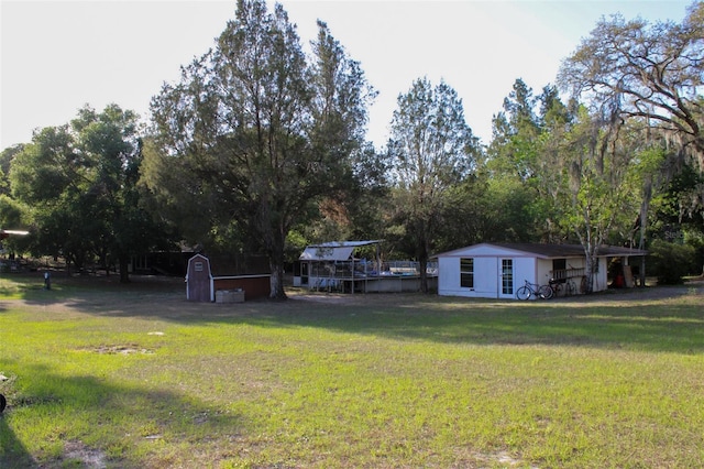 16536 Caldwell Ln, Spring Hill, FL 34610 - view of yard with a storage unit and an outdoor structure