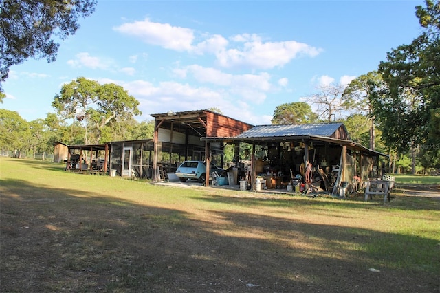 16536 Caldwell Ln, Spring Hill, FL 34610 - view of pole building with a yard and a carport