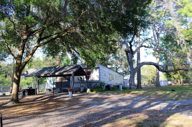 16536 Caldwell Ln, Spring Hill, FL 34610 - exterior space with dirt driveway, fence, and a carport
