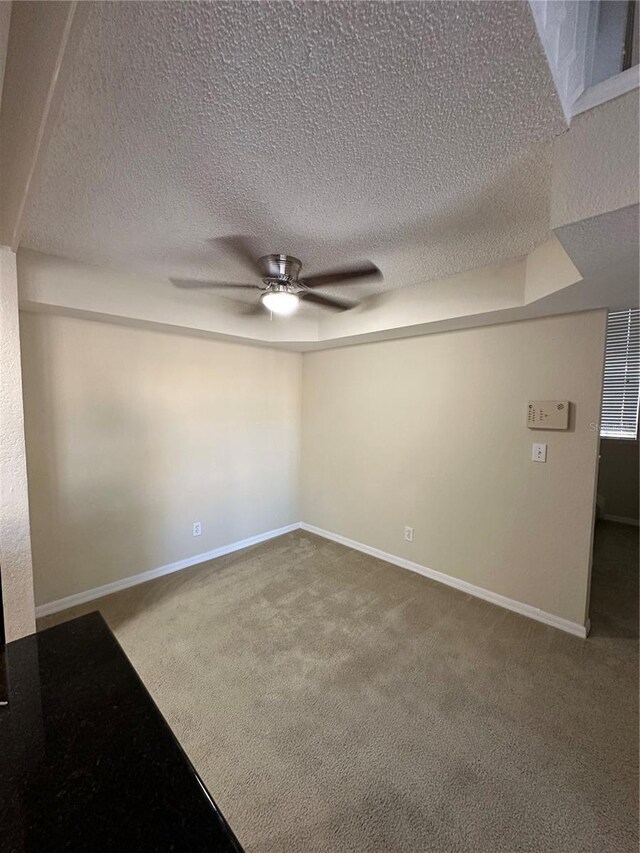 3260 Haviland Ct Unit 202, Palm Harbor, FL 34684 - carpeted empty room featuring baseboards, a ceiling fan, and a textured ceiling