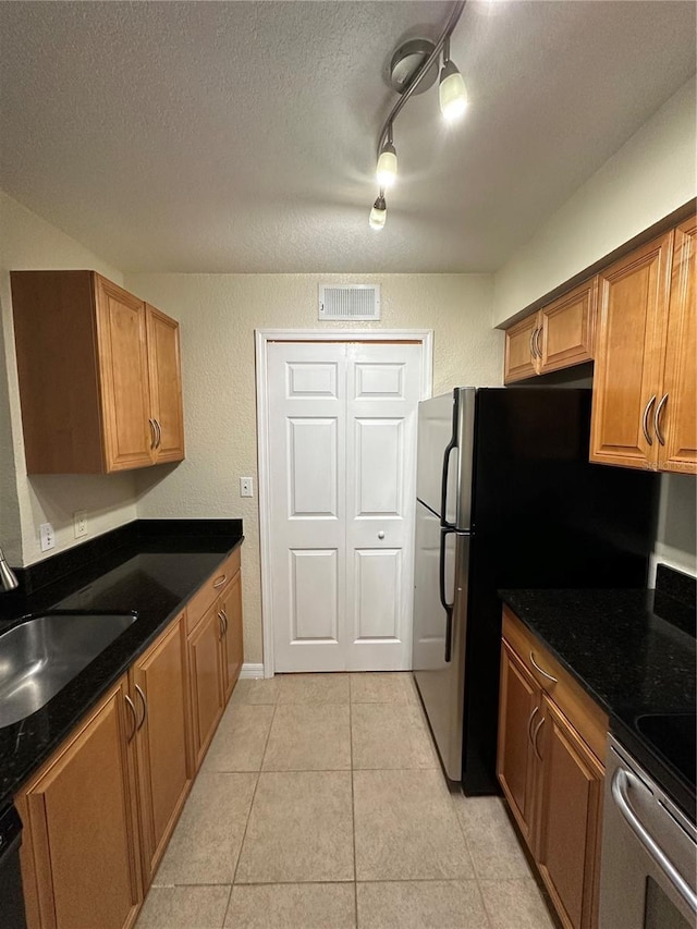 3260 Haviland Ct Unit 202, Palm Harbor, FL 34684 - kitchen featuring light tile patterned floors, stove, a textured ceiling, and visible vents