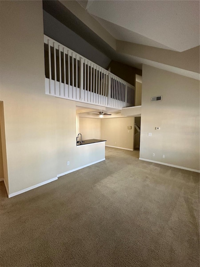 3260 Haviland Ct Unit 202, Palm Harbor, FL 34684 - unfurnished living room featuring carpet floors, high vaulted ceiling, ceiling fan, and baseboards