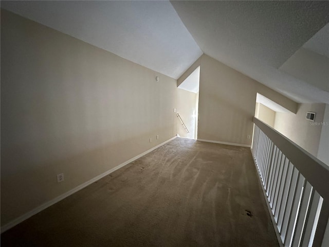 3260 Haviland Ct Unit 202, Palm Harbor, FL 34684 - bonus room featuring baseboards, carpet flooring, and vaulted ceiling