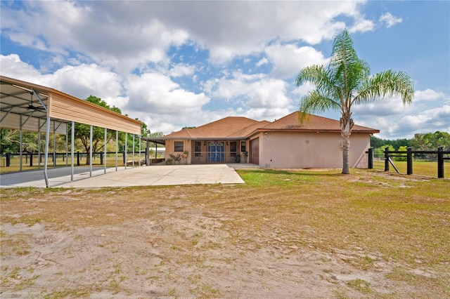 back of property with a patio and a carport