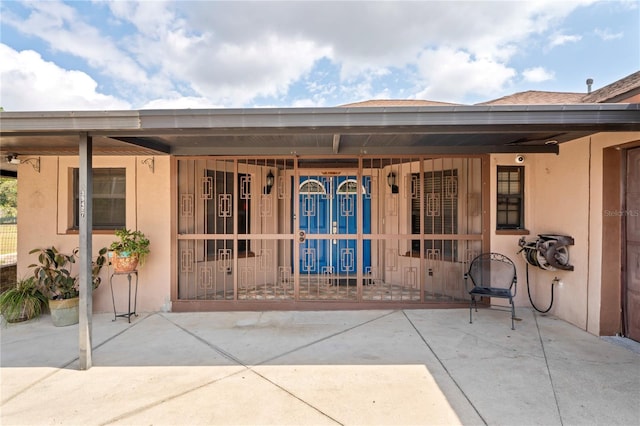 doorway to property with stucco siding