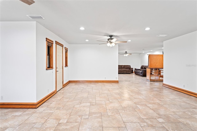 unfurnished living room featuring recessed lighting, ceiling fan, and baseboards