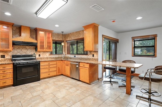 kitchen featuring gas stove, stainless steel dishwasher, backsplash, custom exhaust hood, and plenty of natural light