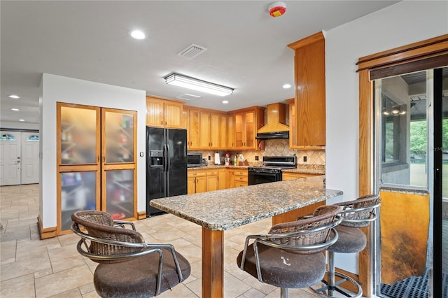 kitchen with black appliances, custom exhaust hood, backsplash, a peninsula, and light stone countertops