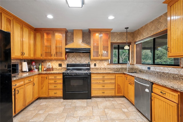 kitchen with black appliances, custom range hood, a sink, backsplash, and light stone finish flooring