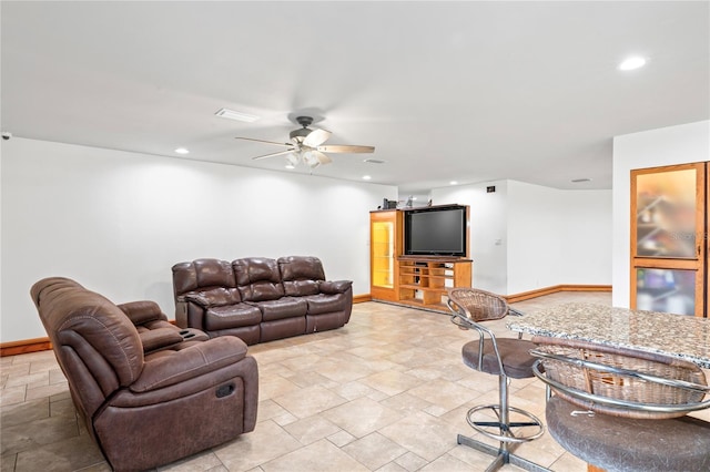 living area with baseboards, stone tile flooring, ceiling fan, and recessed lighting