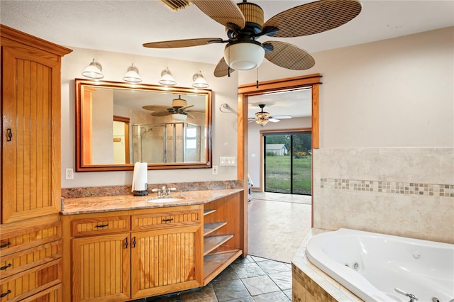 full bath featuring ceiling fan, a jetted tub, vanity, and an enclosed shower