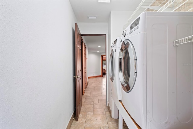 washroom featuring stone tile flooring, independent washer and dryer, baseboards, and recessed lighting